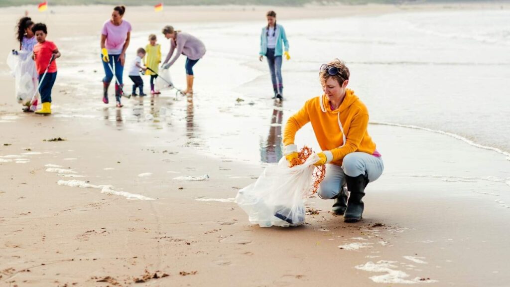 Image of beach cleaning by Canva. Blog Post on Best Eco Friendly Beach Ideas - (2024) by wecareearth.com 
#ecofriendlybeach
#sustainablebeachday
#responsibletourism
#zerowastebeach
#beachcleanup
