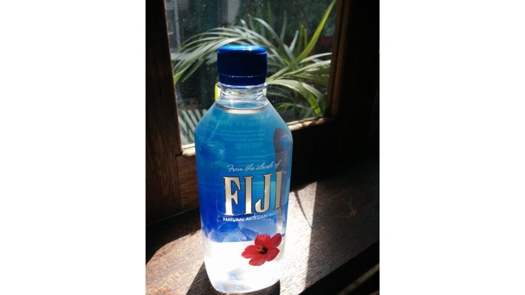 A bottle of Fiji water. The label highlights Natural Artesian Water. 